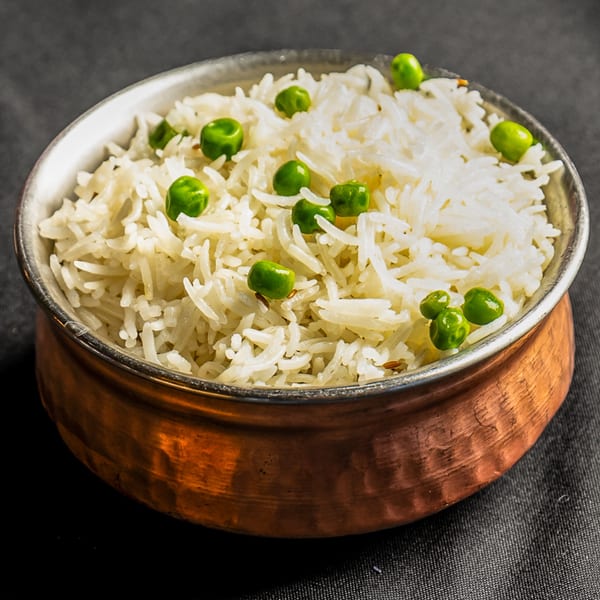 Basmati rice with green peas, served in a hammered copper bowl from India Express Denver.