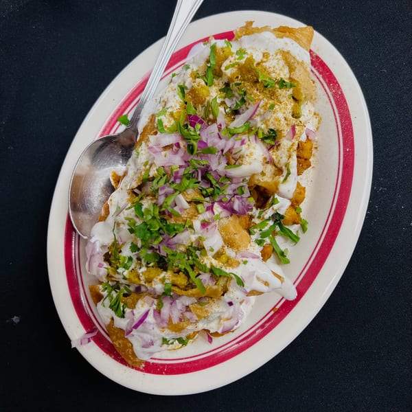 Indian Express Denver's papri chaat, topped with yogurt, red onions, cilantro, and spices.