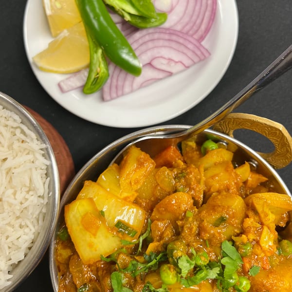 Indian Express Denver's Aloo Gobi with rice, lemon, green chilies, and red onions.