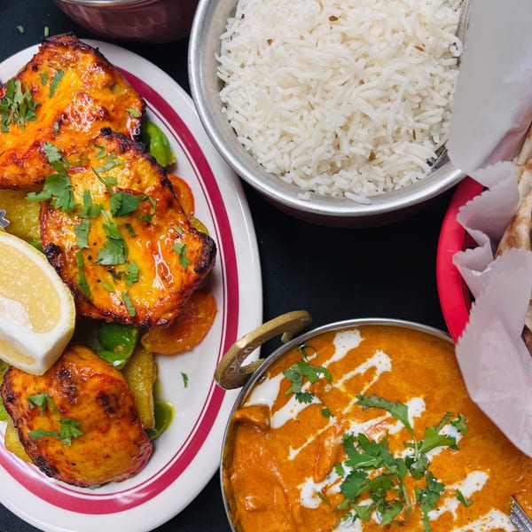 Indian Express Denver's chicken tikka, rice, butter chicken, and naan bread.