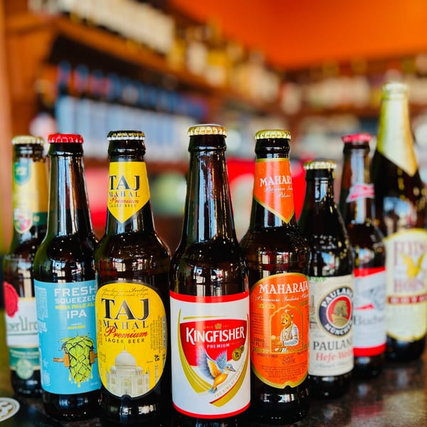 A variety of Indian and international beer bottles, including Kingfisher, Taj Mahal, and Maharaja.